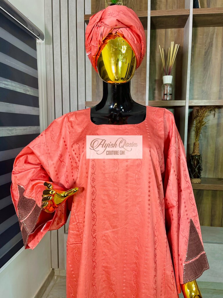 The Coral Mosaic coral pink dress with brown geometric detailing and matching headwrap by Ayish Qasim