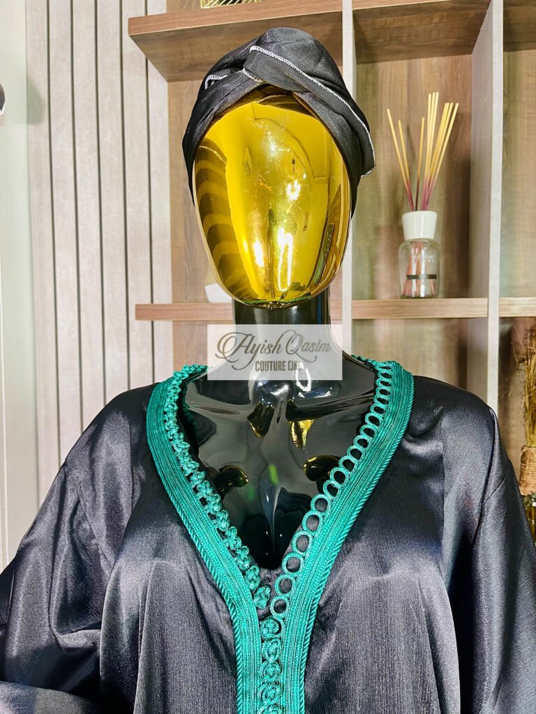 The Jade Nocturne black dress with emerald green detailing and matching headwrap by Ayish Qasim