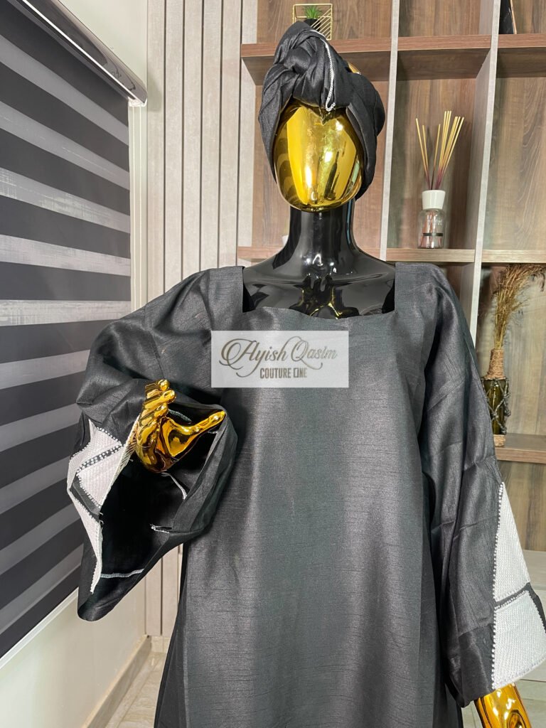 The Noir Atelier black African dress with white geometric detailing and matching headwrap by Ayish Qasim