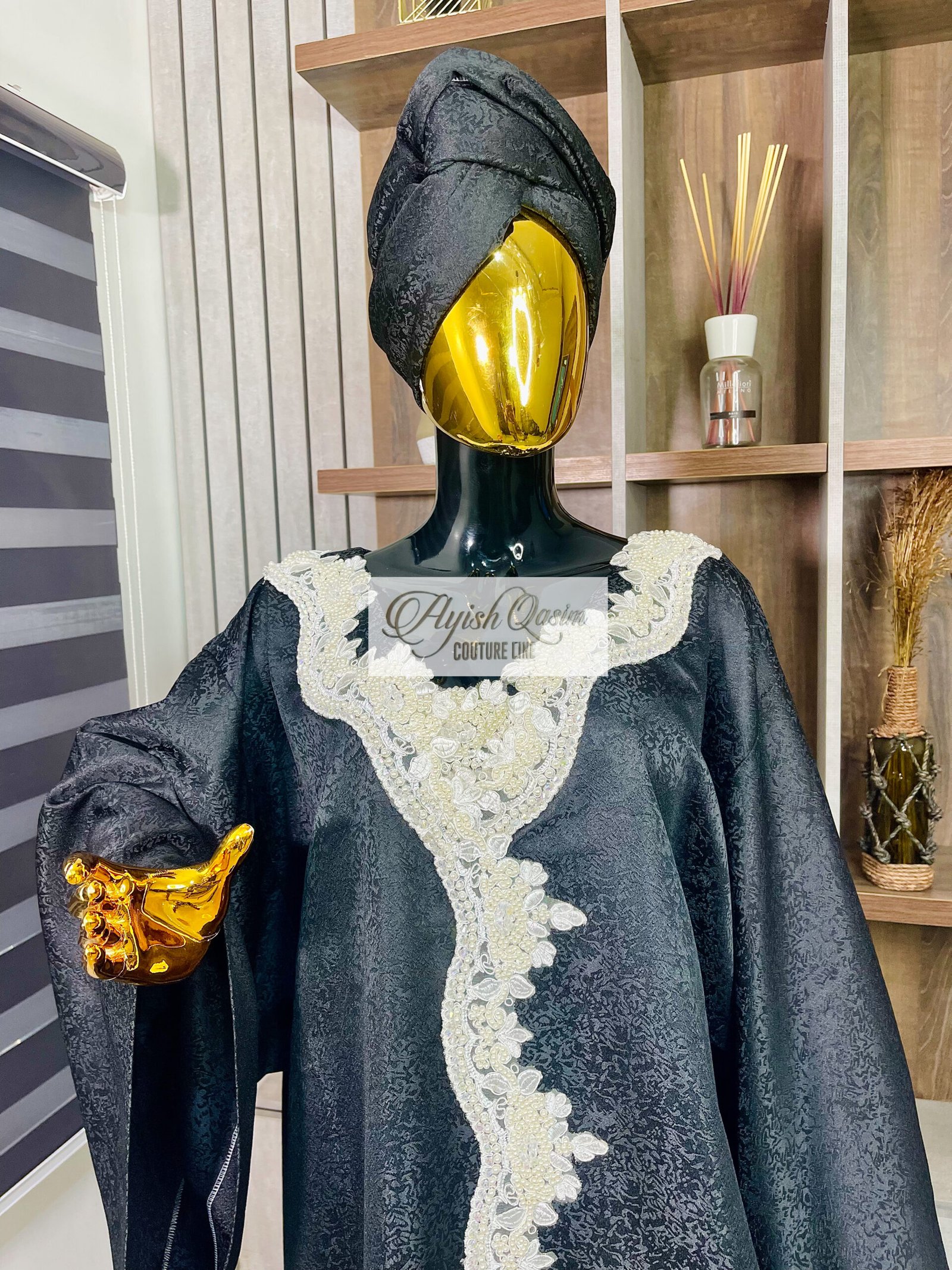 The Noir Étoile black African dress with ivory lace detailing and wide sleeves by Ayish Qasim