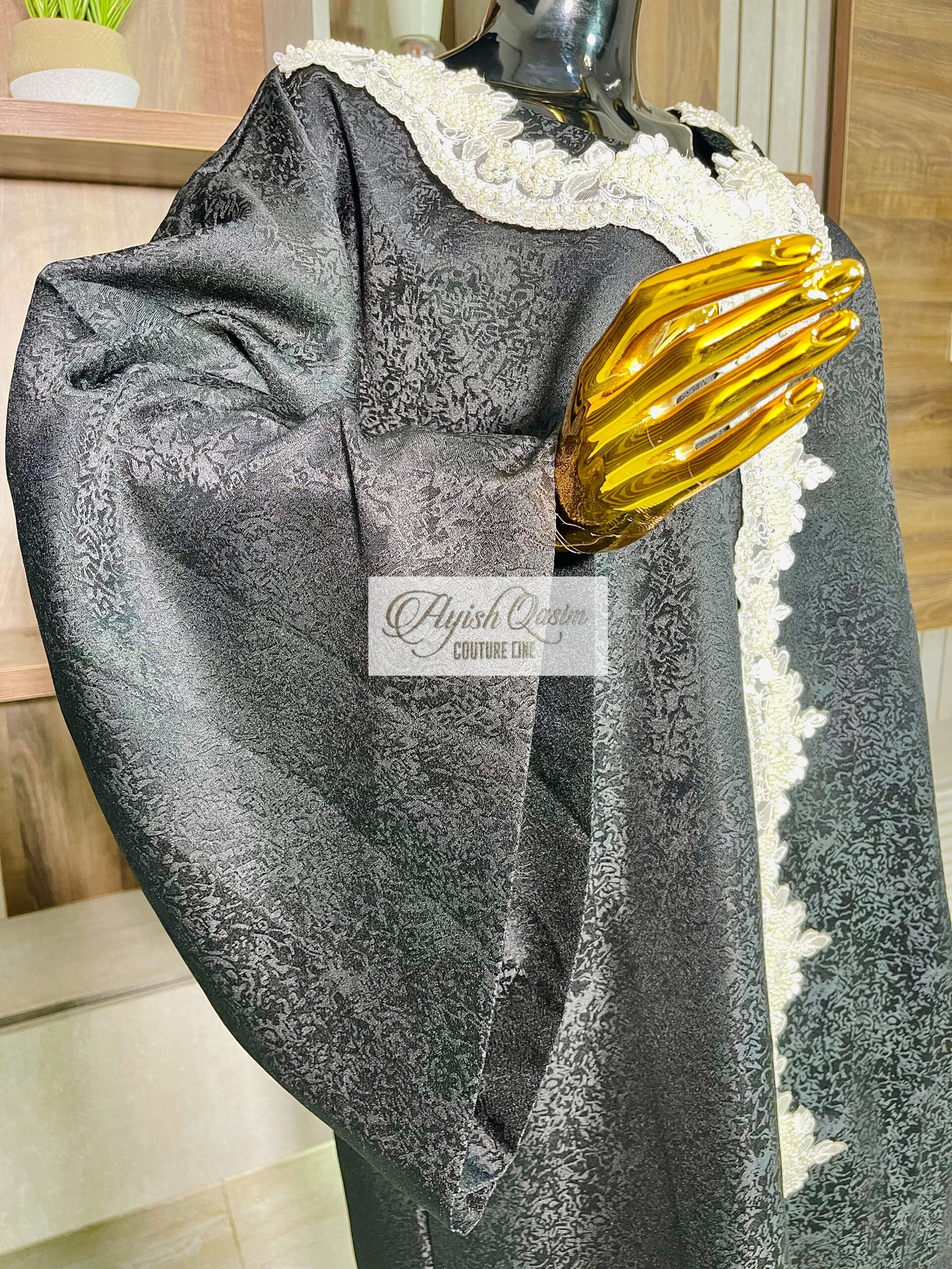 The Noir Étoile black African dress with ivory lace detailing and wide sleeves by Ayish Qasim