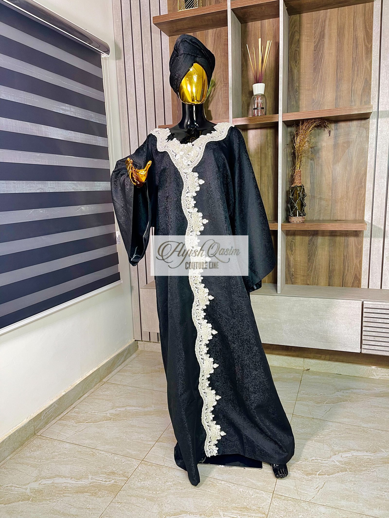 The Noir Étoile black African dress with ivory lace detailing and wide sleeves by Ayish Qasim