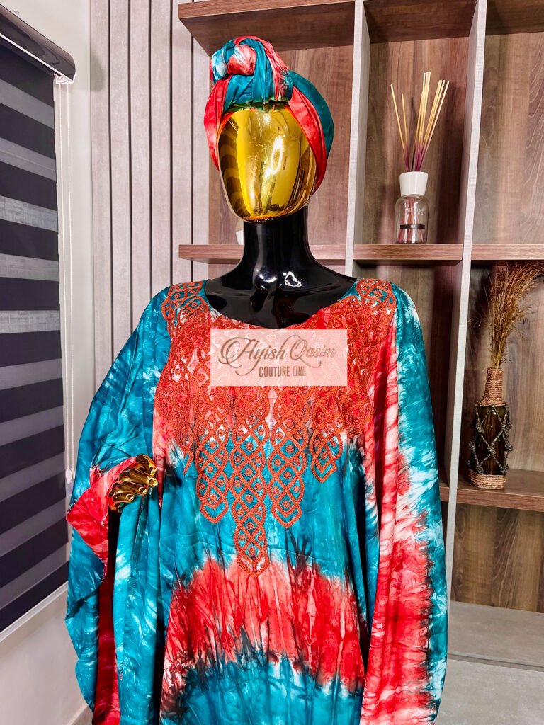 The Ocean Ember turquoise and coral tie-dye dress with embroidered detailing and matching headwrap by Ayish Qasim