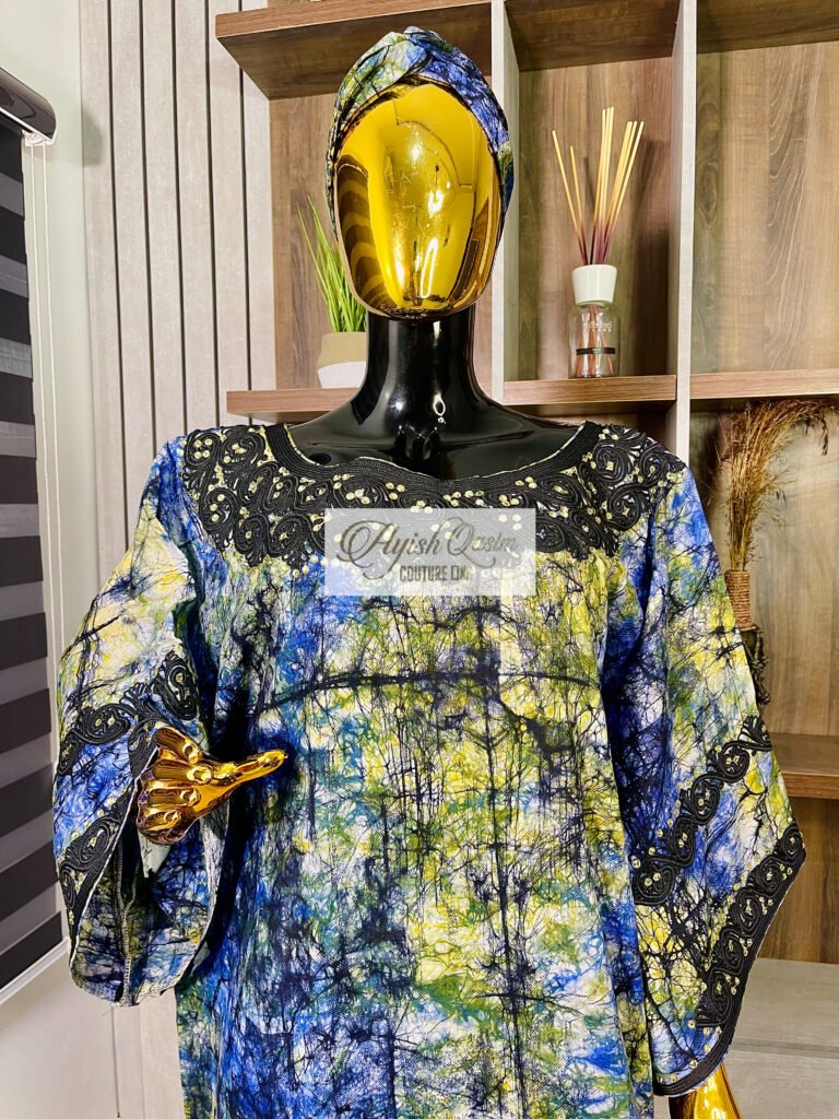 The Sapphire Botanique blue African dress with green and yellow patterned detailing and black lace accents by Ayish Qasim