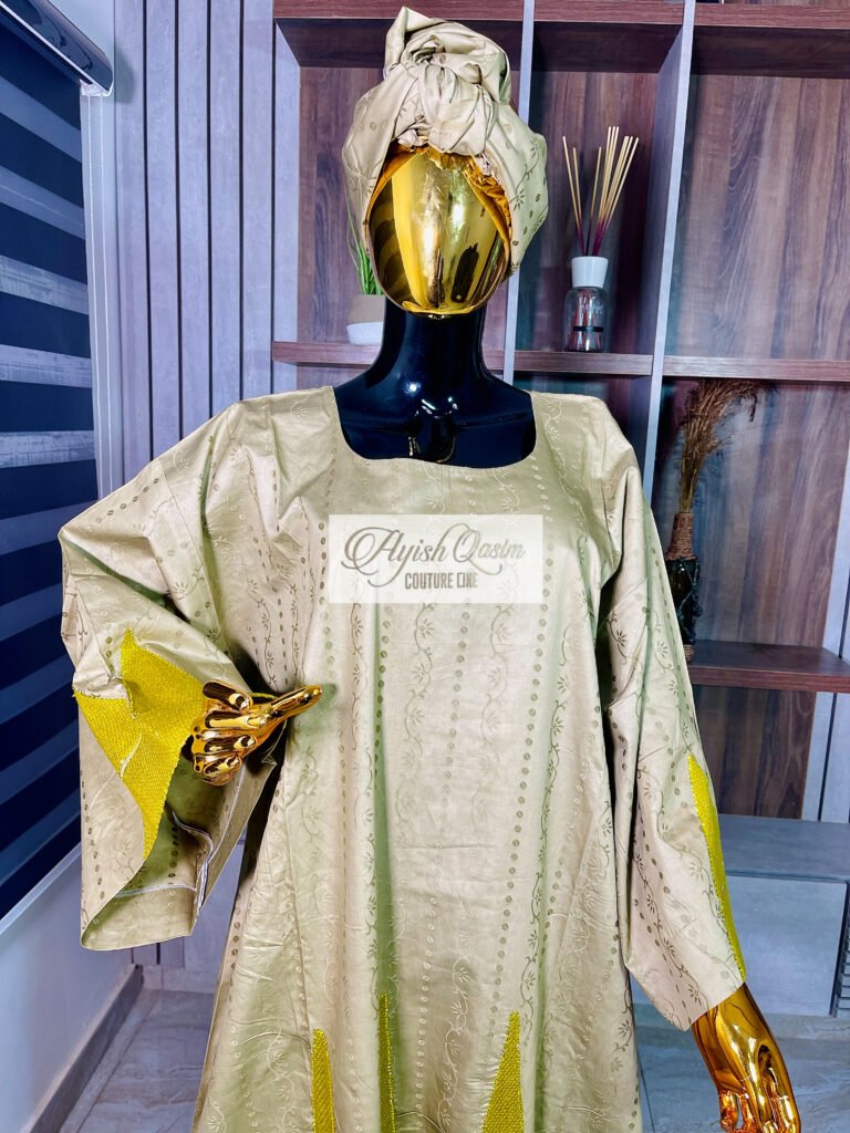 The Solara gold-green dress with geometric gold detailing and matching headwrap by Ayish Qasim